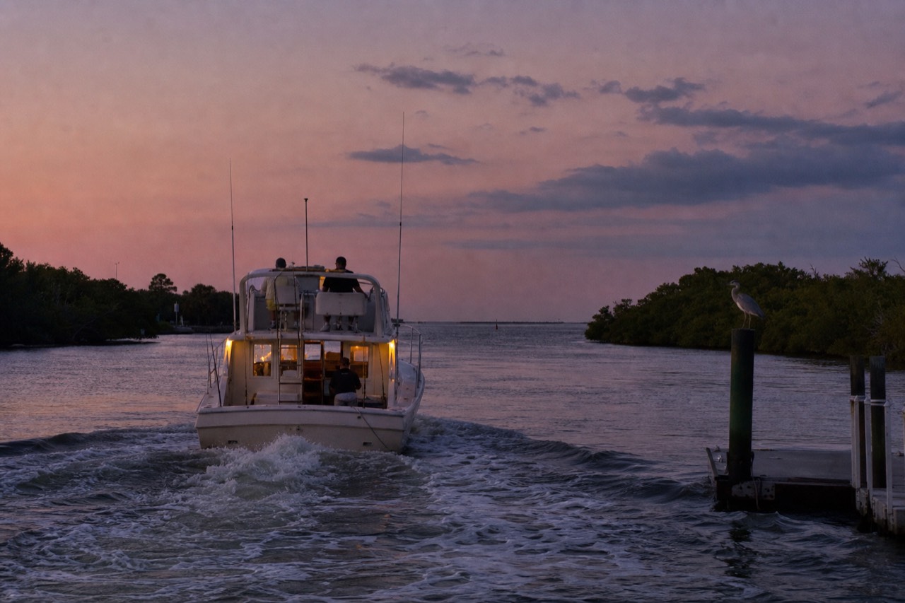 A small boat cruising the Intracoastal Waterway at dusk near Fort Lauderdale, no text, no logos, no people