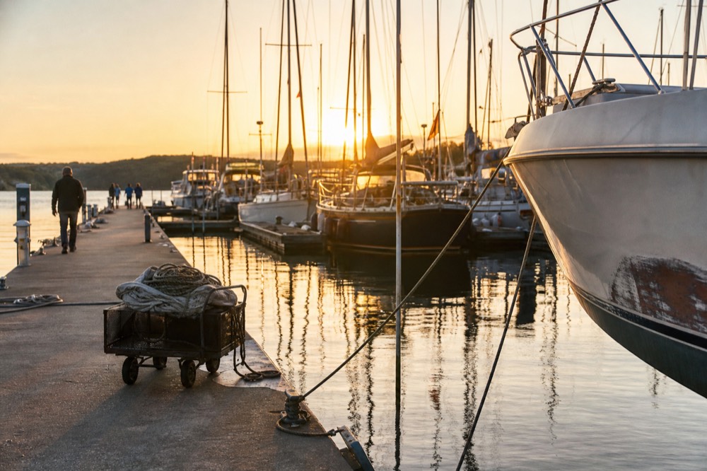 Golden hour light over the Intracoastal Waterway with yachts at dock, no text, no logos, no people