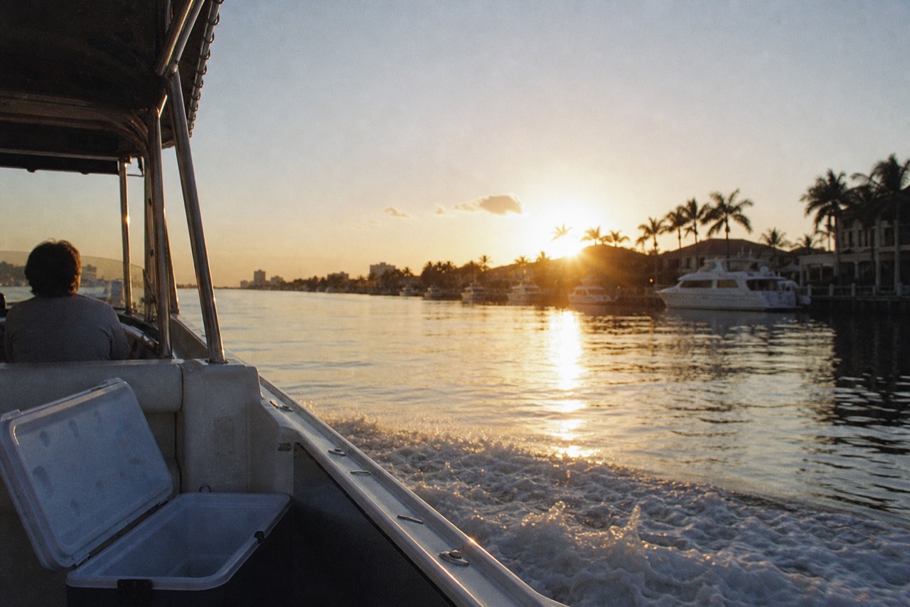 A boat cruising the Intracoastal Waterway at golden hour near Fort Lauderdale, no text, no logos, no people