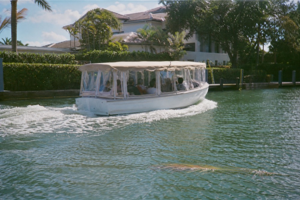 A water taxi boat cruising the Intracoastal Waterway past waterfront homes, no text, no logos, no people