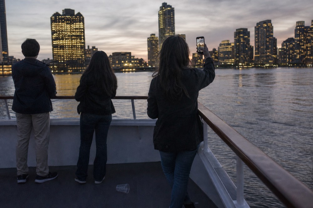 Guests on a sunset cruise looking at the skyline, no text, no logos, no people