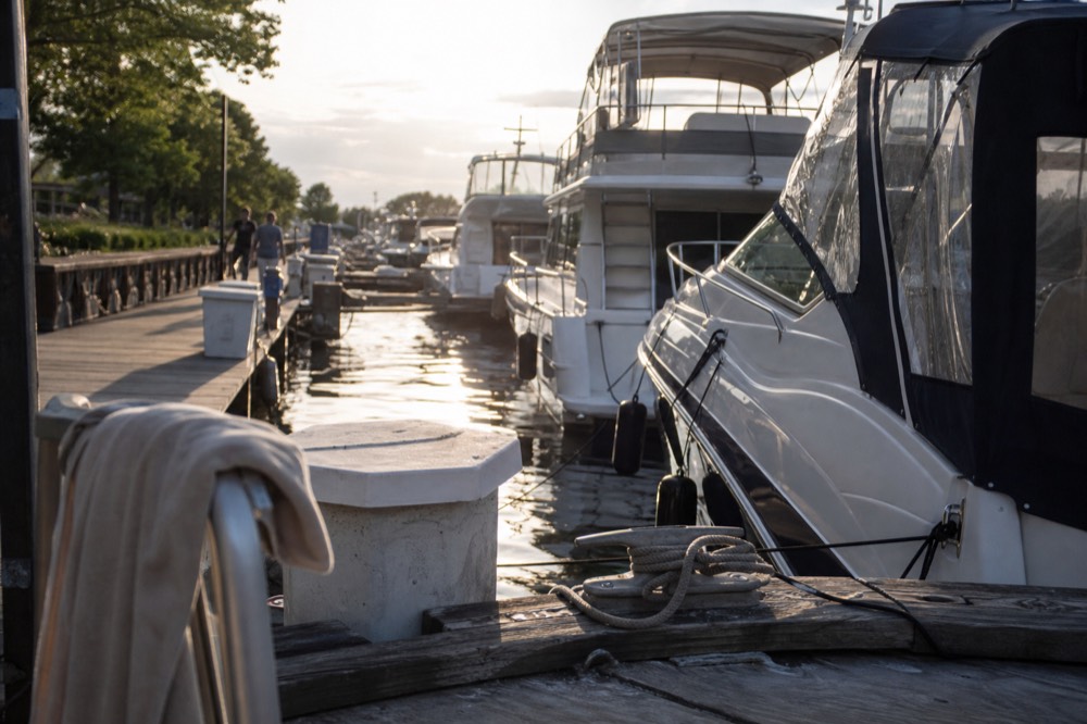 Marina docks with yachts and tour boats moored for the evening, no text, no logos, no people.
